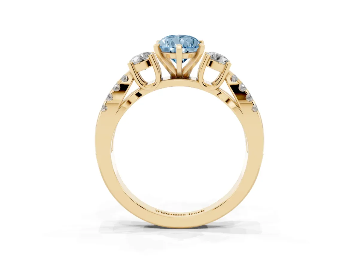 Fancy Blue Pear Cut Diamond Three-Stone Ring with Pavé Split Shank and Four-Prong Setting Yellow gold