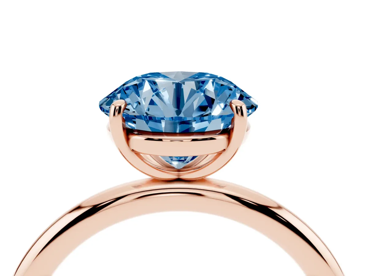 Fancy Blue Round Cut Solitaire Diamond Ring with Four-Prong Setting on a Plain Band Rose gold