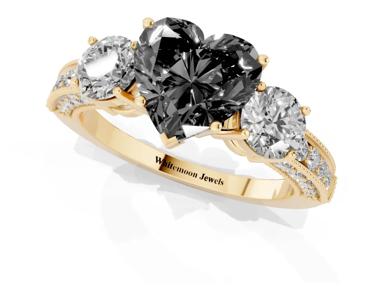 Fancy Black Heart Cut Three-Stone Diamond Ring with Pavé Band and Four-Prong Setting Yellow gold