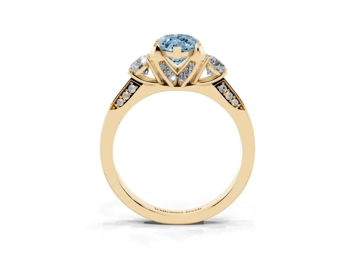 Fancy Blue Marquise Cut Brilliant Three-Stone Diamond Ring with Pavé Band and Four-Prong Setting Yellow gold