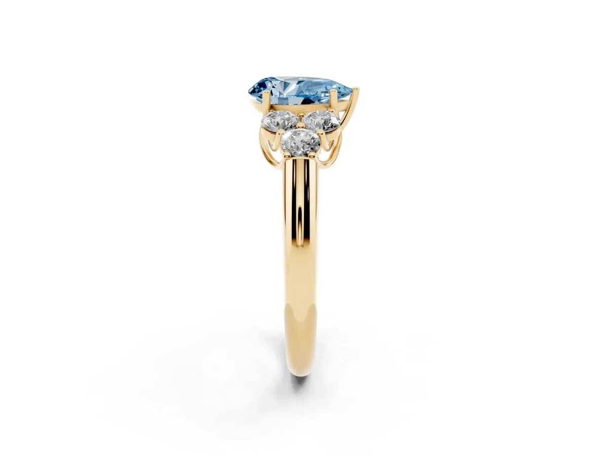 Fancy Blue Pear Cut Cut Diamond Cluster Ring with Round Accent Stones and Prong Setting on a Classic Band Yellow gold