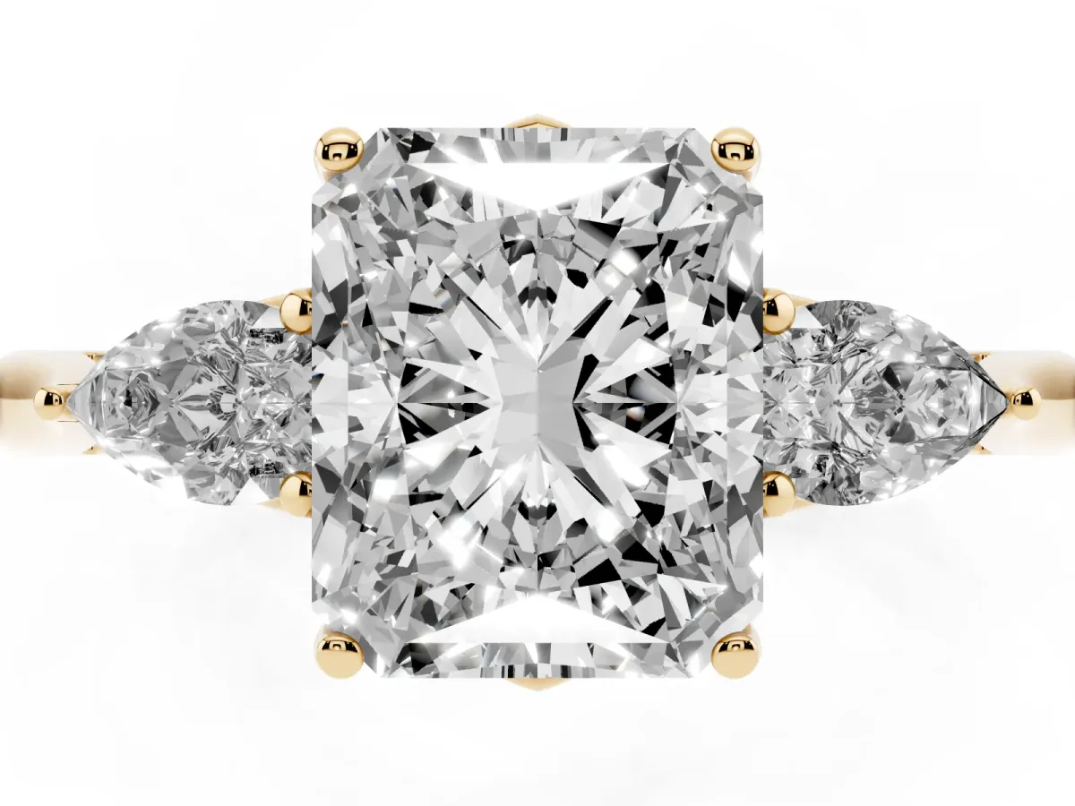 Radiant Cut Diamond Three-Stone Ring with Pear Side Stones and Prong Setting Yellow gold