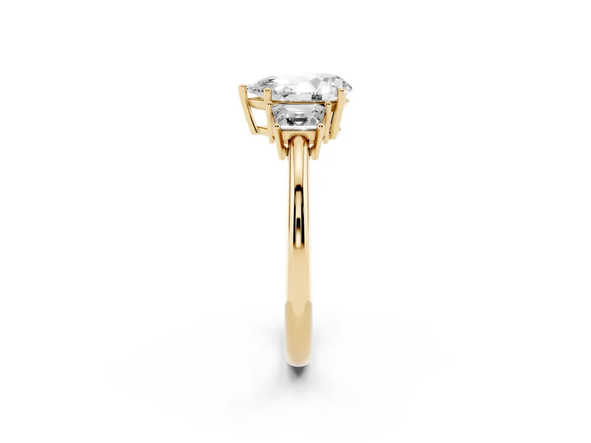 Pear Cut Diamond Three-Stone Ring with Trapezoid Side Stones and Prong Setting Yellow gold
