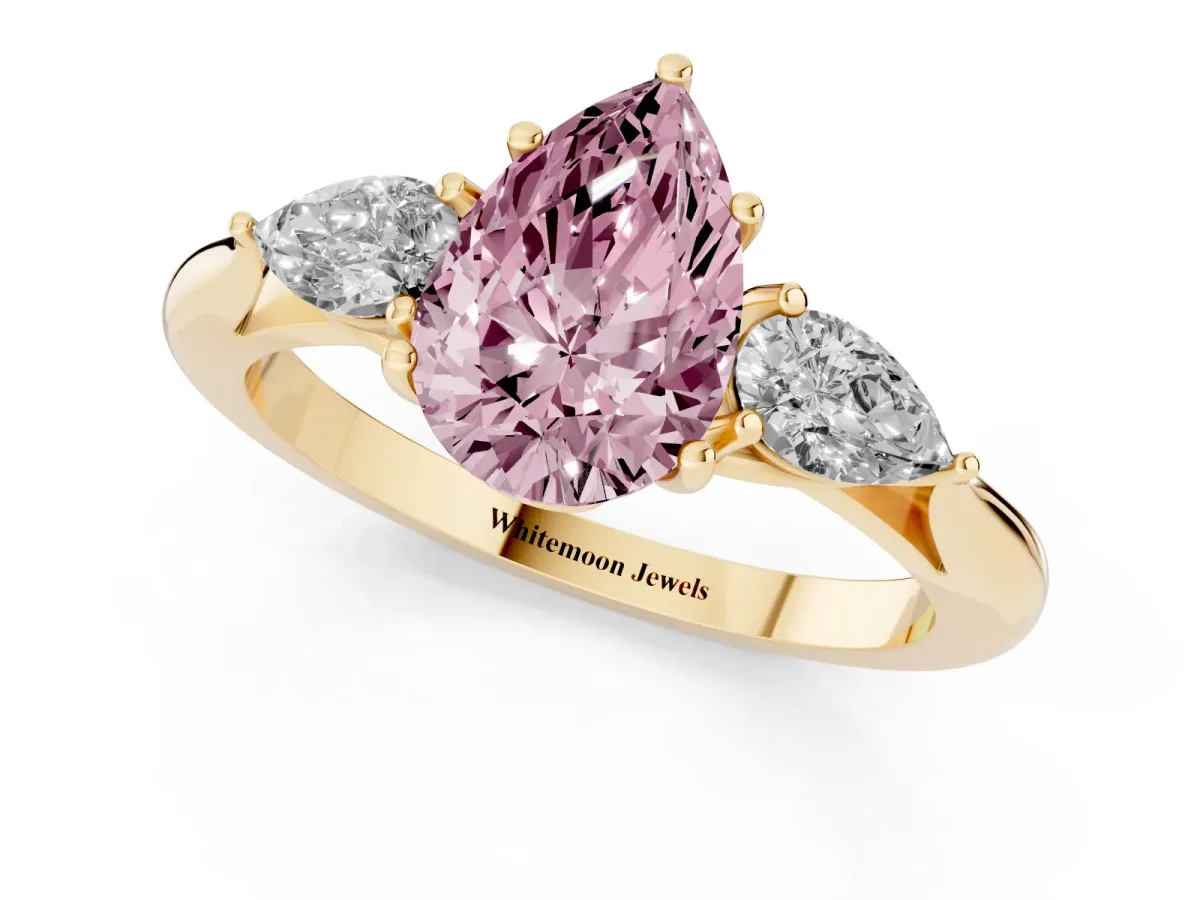Fancy Pink Pear Cut Diamond Three-Stone Ring with Pear Side Stones and Prong Setting Yellow gold