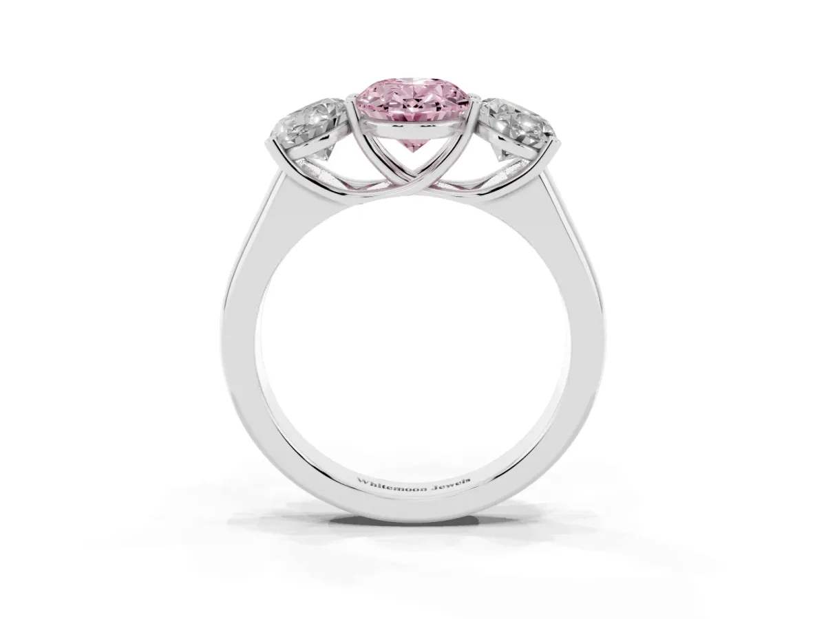 Fancy Pink Oval Cut Three-Stone Diamond Ring with Prong Setting on a Classic Band Platinum