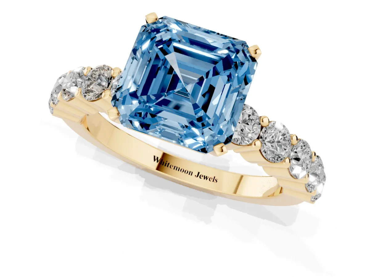 Fancy Blue Asscher Cut Diamond Solitaire Ring with Shared Prong Round Side Stones Yellow gold