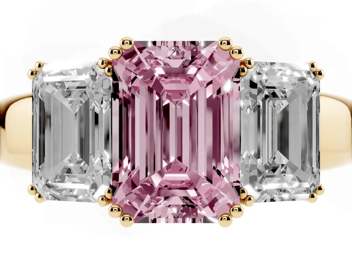 Fancy Pink Three-Stone Emerald Cut Cut Diamond Ring with Channel Set Band and Four-Prong Setting Yellow gold