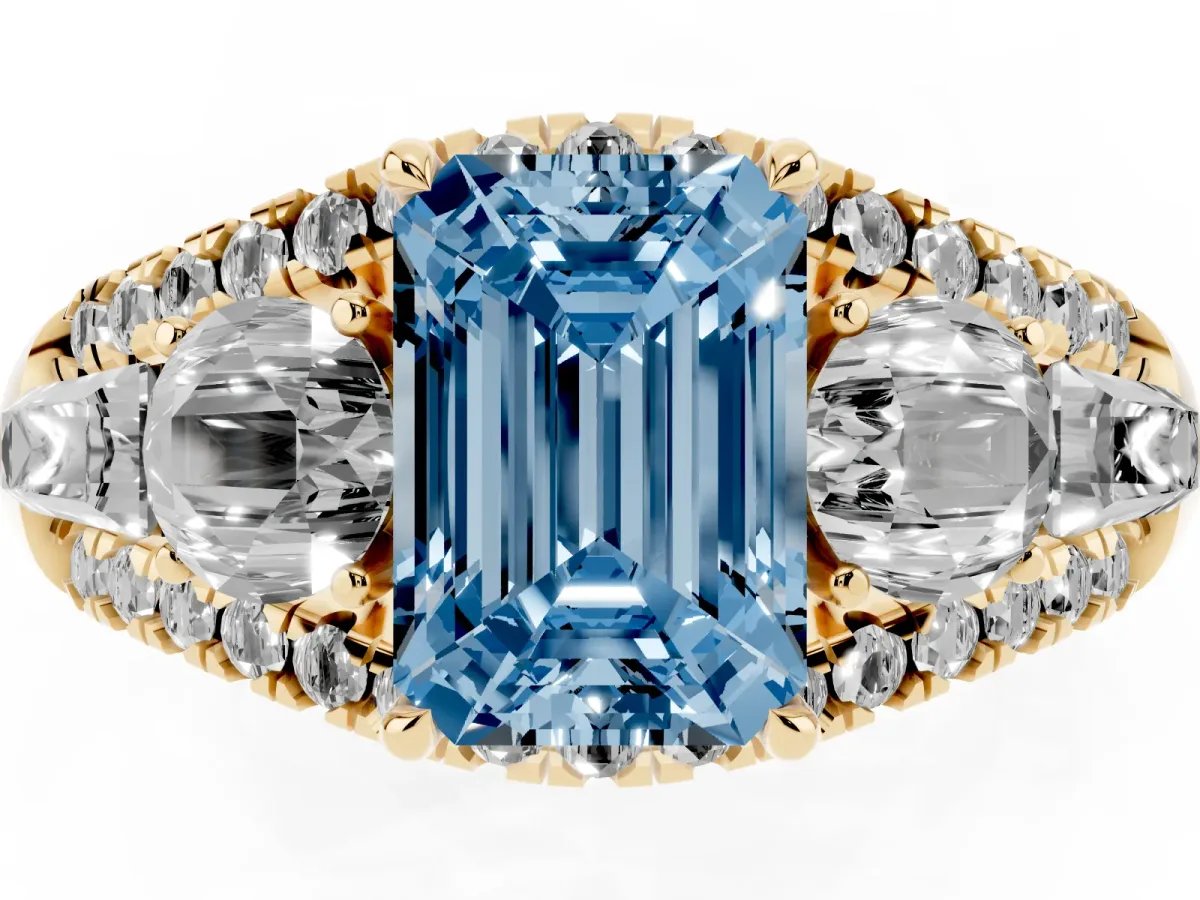 Fancy Blue Three-Stone Emerald Cut Diamond Engagement Ring with Pave Band and Prong Setting Yellow gold