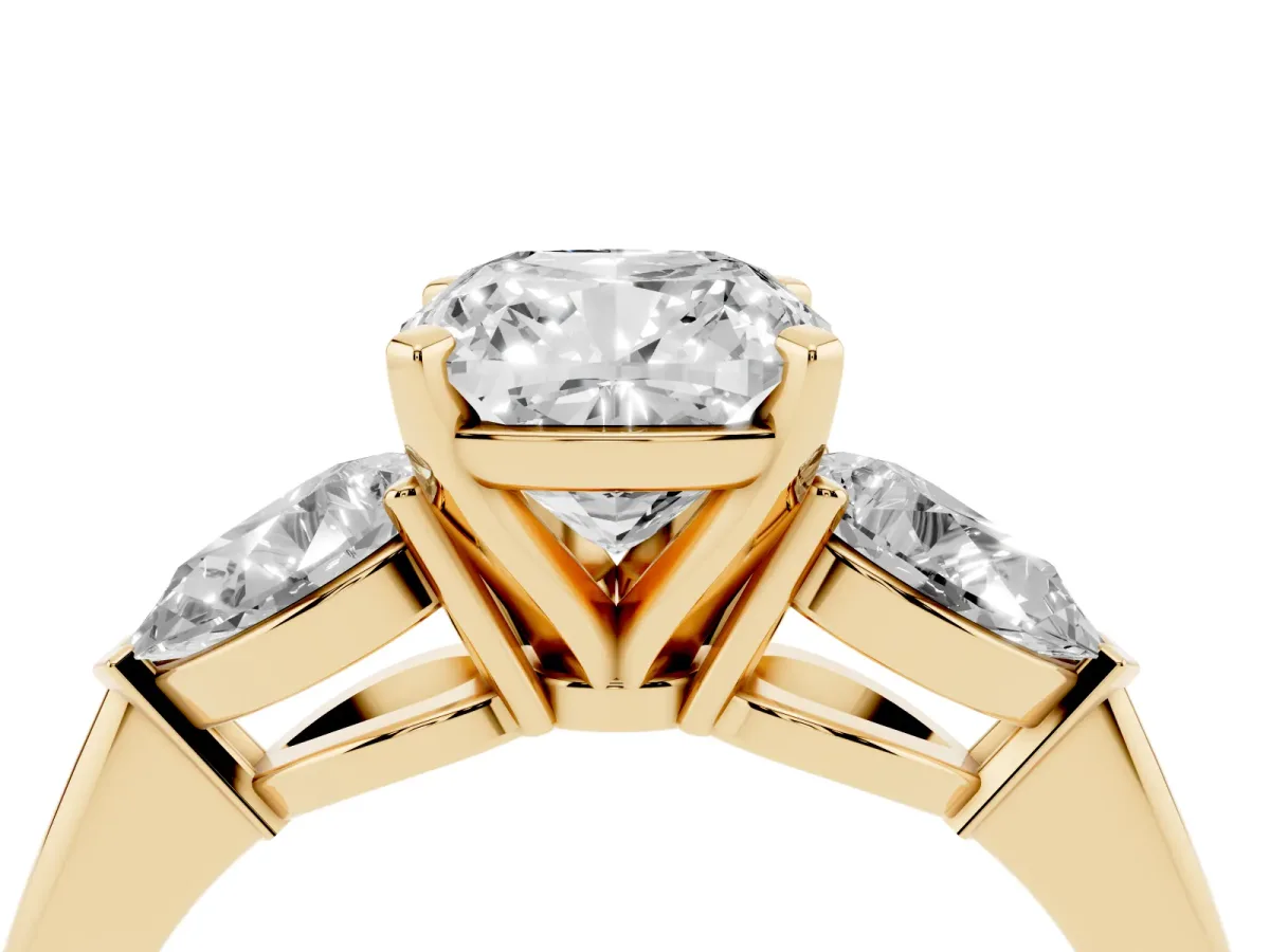Three-Stone Cushion Cut Diamond Ring with Pear Side Stones and Four-Prong Setting Yellow gold