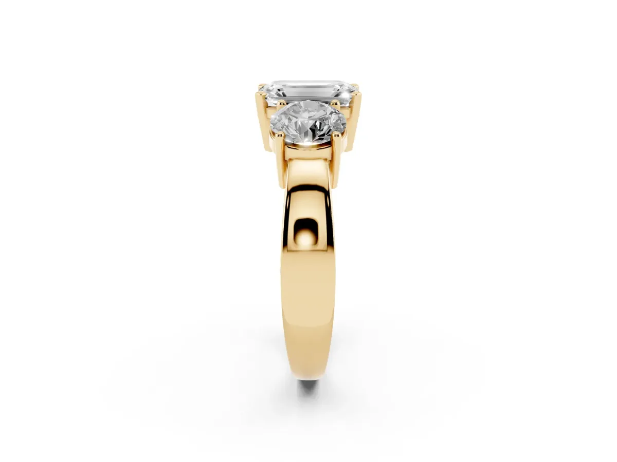 Three-Stone Emerald Cut Diamond Ring with Round Side Stones, Classic Band, and Four-Prong Setting Yellow gold