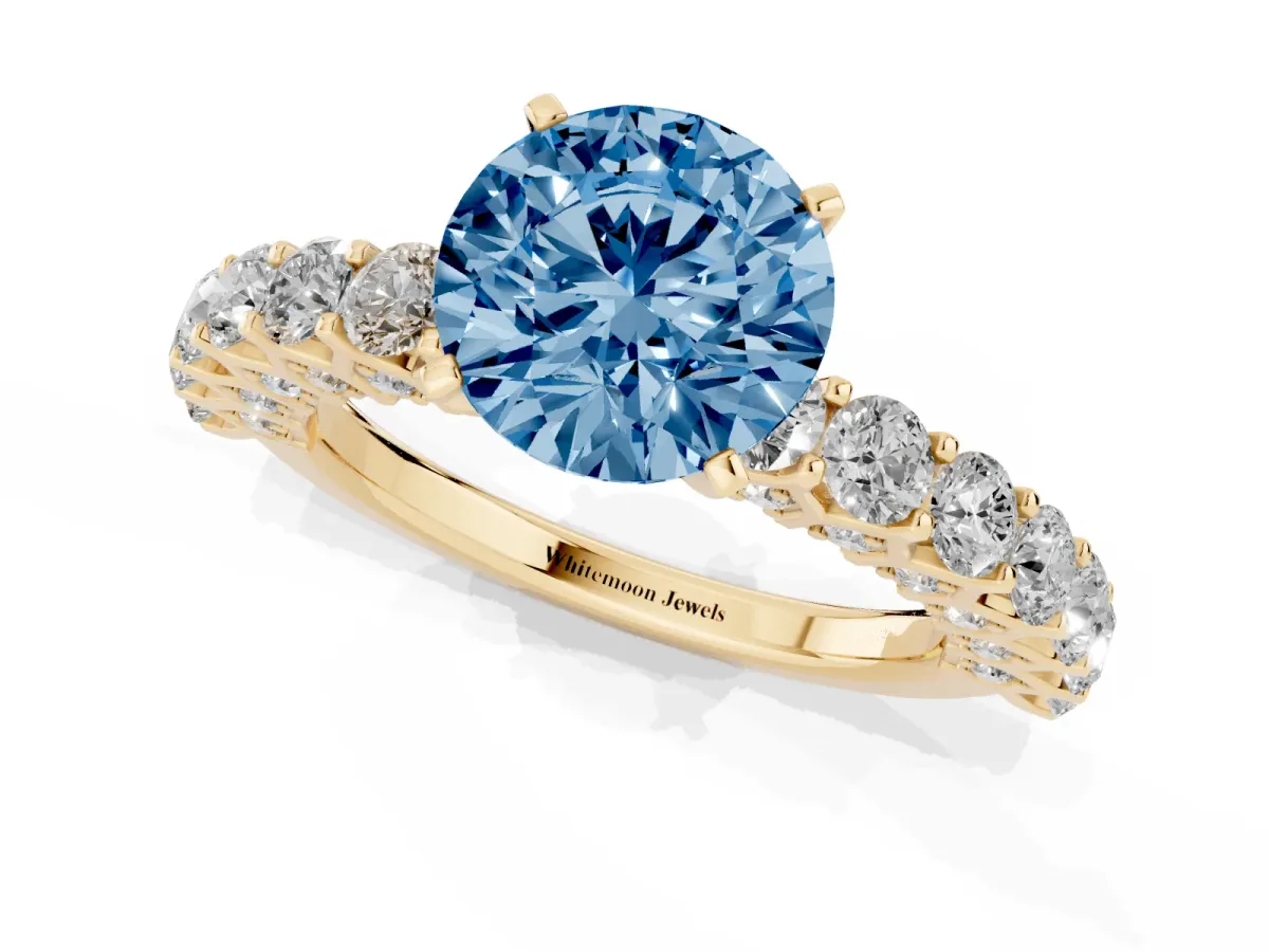 Fancy Blue Round Cut Diamond Solitaire Ring with Shared Prong Pavé Band and Four-Prong Setting Yellow gold