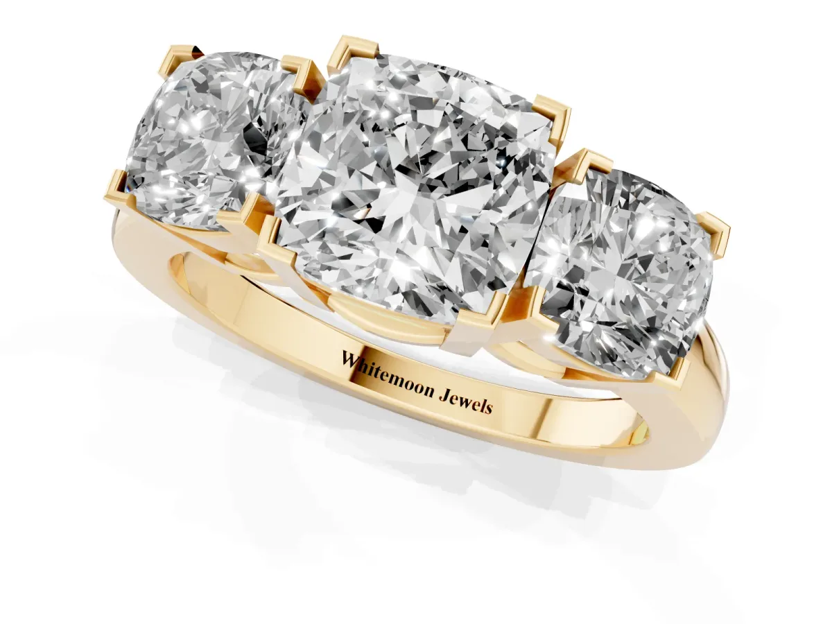 Three-Stone Cushion Cut Cut Diamond Ring with Channel Set Band and Four-Prong Setting Yellow gold