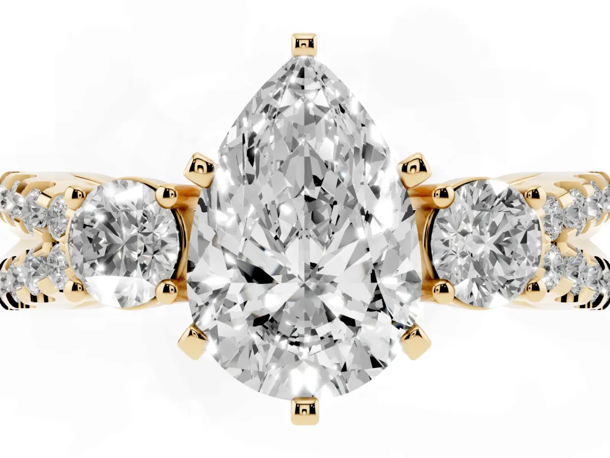 Pear Cut Diamond Three-Stone Ring with Pavé Split Shank and Four-Prong Setting Yellow gold