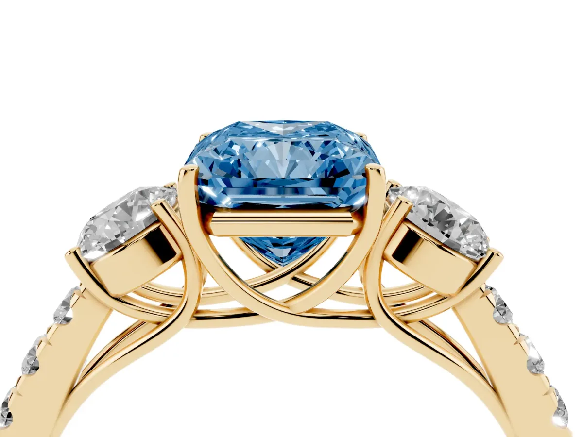 Fancy Blue Radiant Cut Cut Diamond Three-Stone Ring with Round Side Stones and Pavé Band Yellow gold