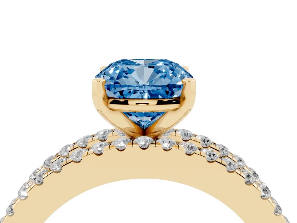 Fancy Blue Cushion Cut Diamond Solitaire Ring with Pavé and Channel Set Band Yellow gold