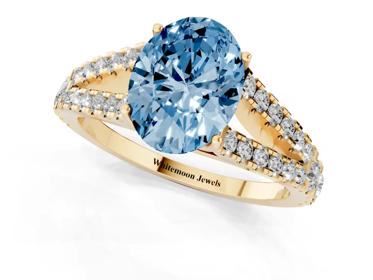 Fancy Blue Oval Cut Diamond Split Shank Pavé Engagement Ring with Four-Prong Setting Yellow gold