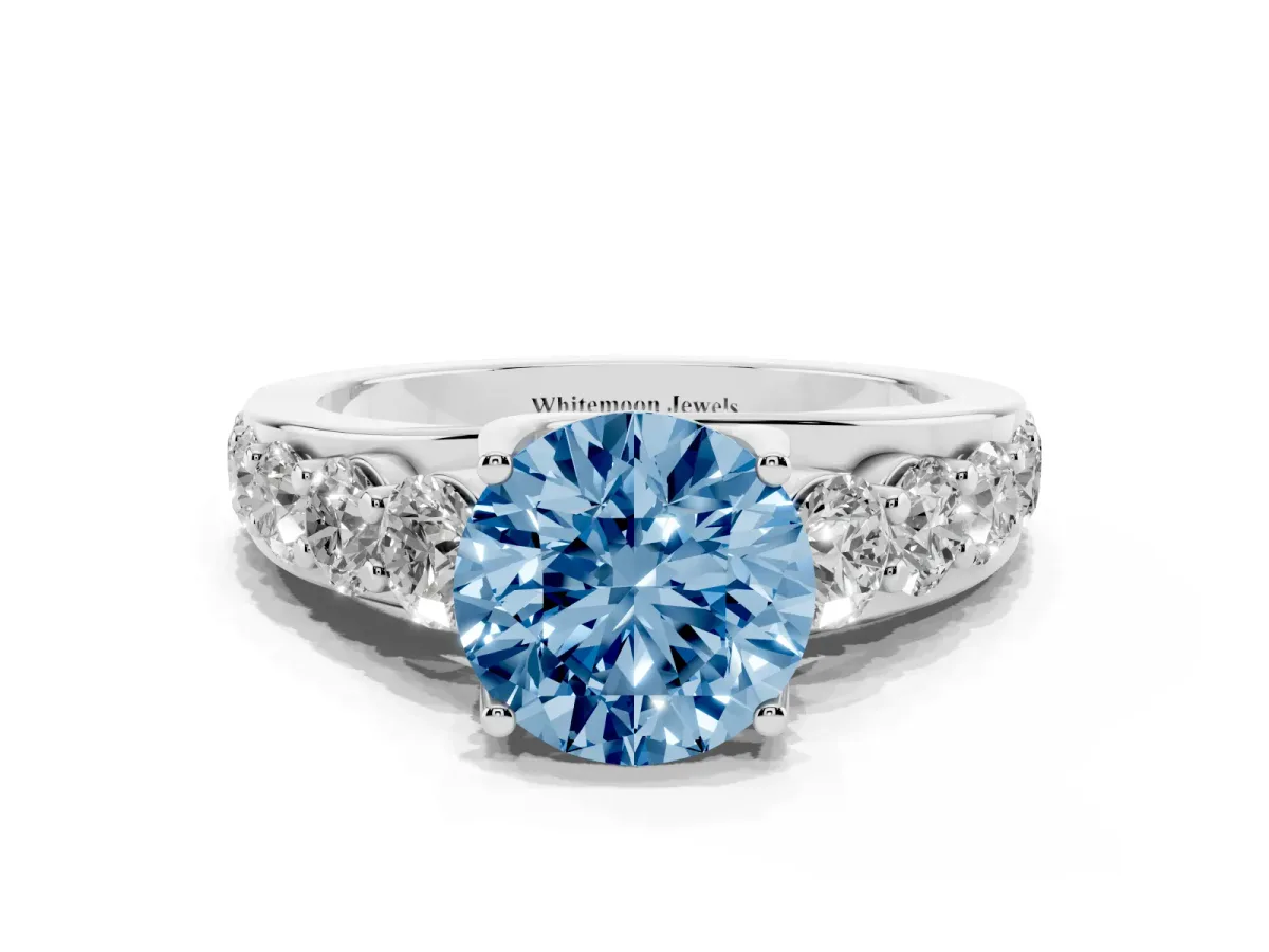 Fancy Blue Round Cut Diamond Engagement Ring with Pavé Band and Four-Prong Setting Silver