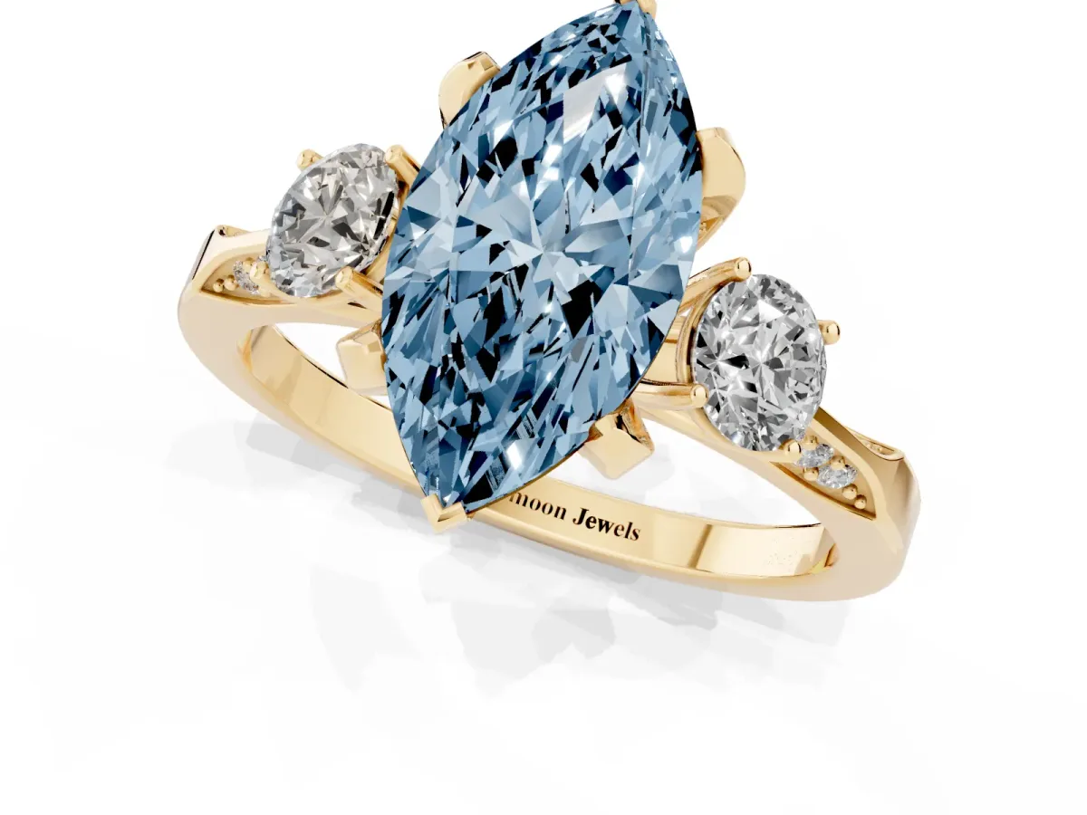 Fancy Blue Marquise Cut Brilliant Three-Stone Diamond Ring with Pavé Band and Four-Prong Setting Yellow gold
