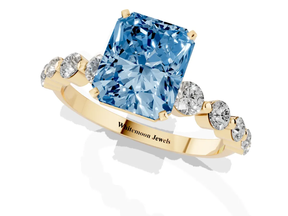 Fancy Blue Radiant Cut Solitaire Diamond Ring with Pave Band and Four-Prong Setting Yellow gold