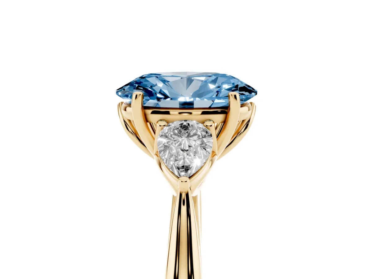 Fancy Blue Oval Cut Diamond Three-Stone Ring with Pear Side Stones and Prong Setting Yellow gold