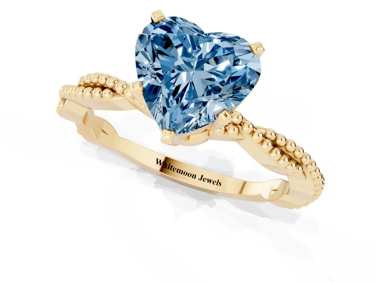 Fancy Blue Heart Cut Solitaire Twisted Band with Bead Prong Setting Yellow gold
