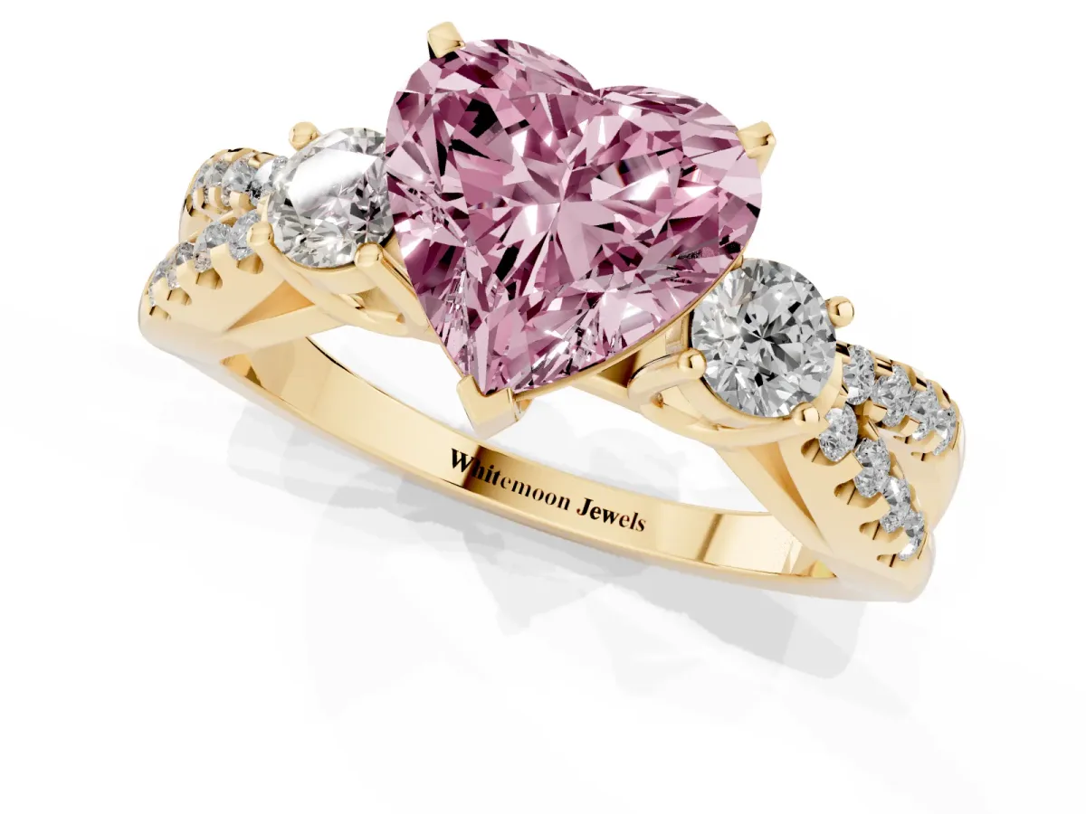 Fancy Pink Heart Cut Diamond Three-Stone Ring with Pavé Split Shank and Four-Prong Setting Yellow gold