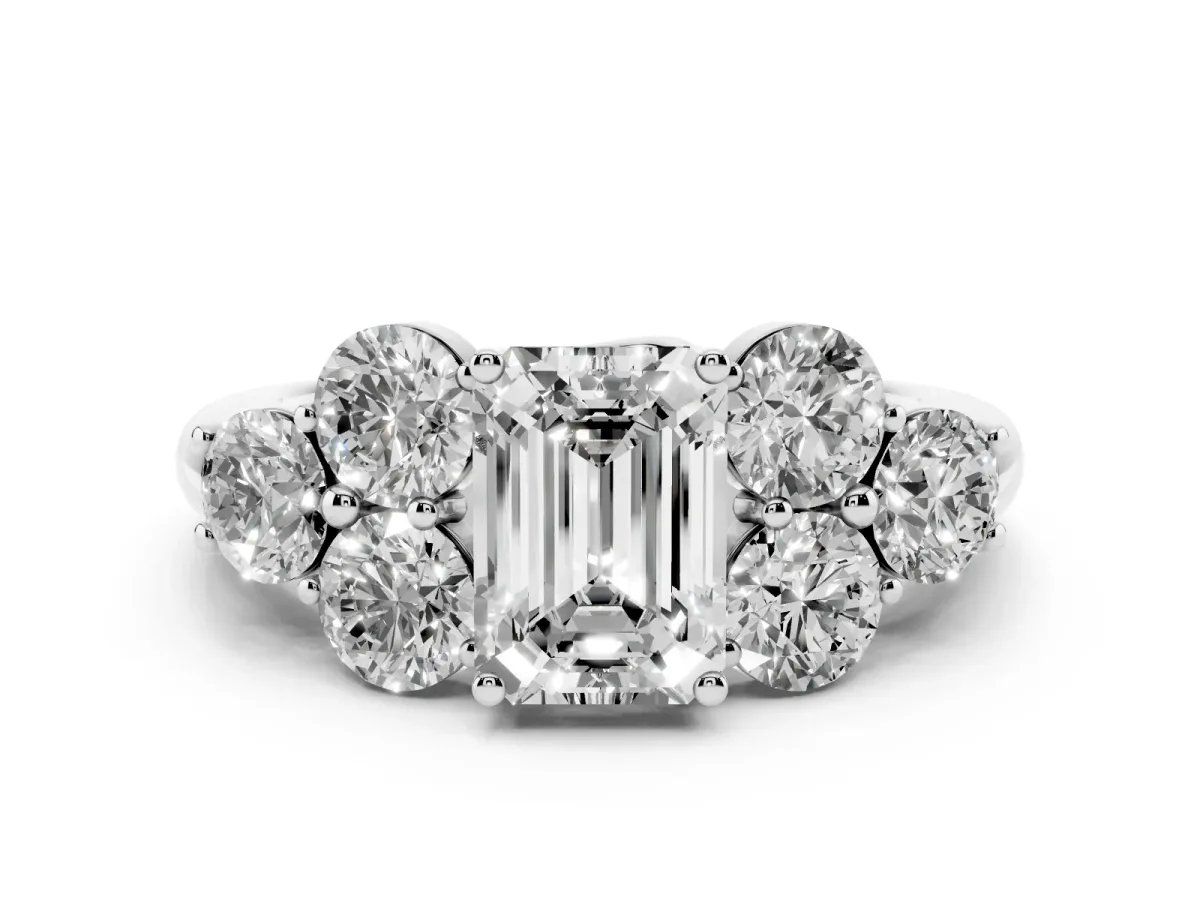 Emerald Cut Cut Diamond Cluster Ring with Round Accent Stones and Prong Setting on a Classic Band Silver