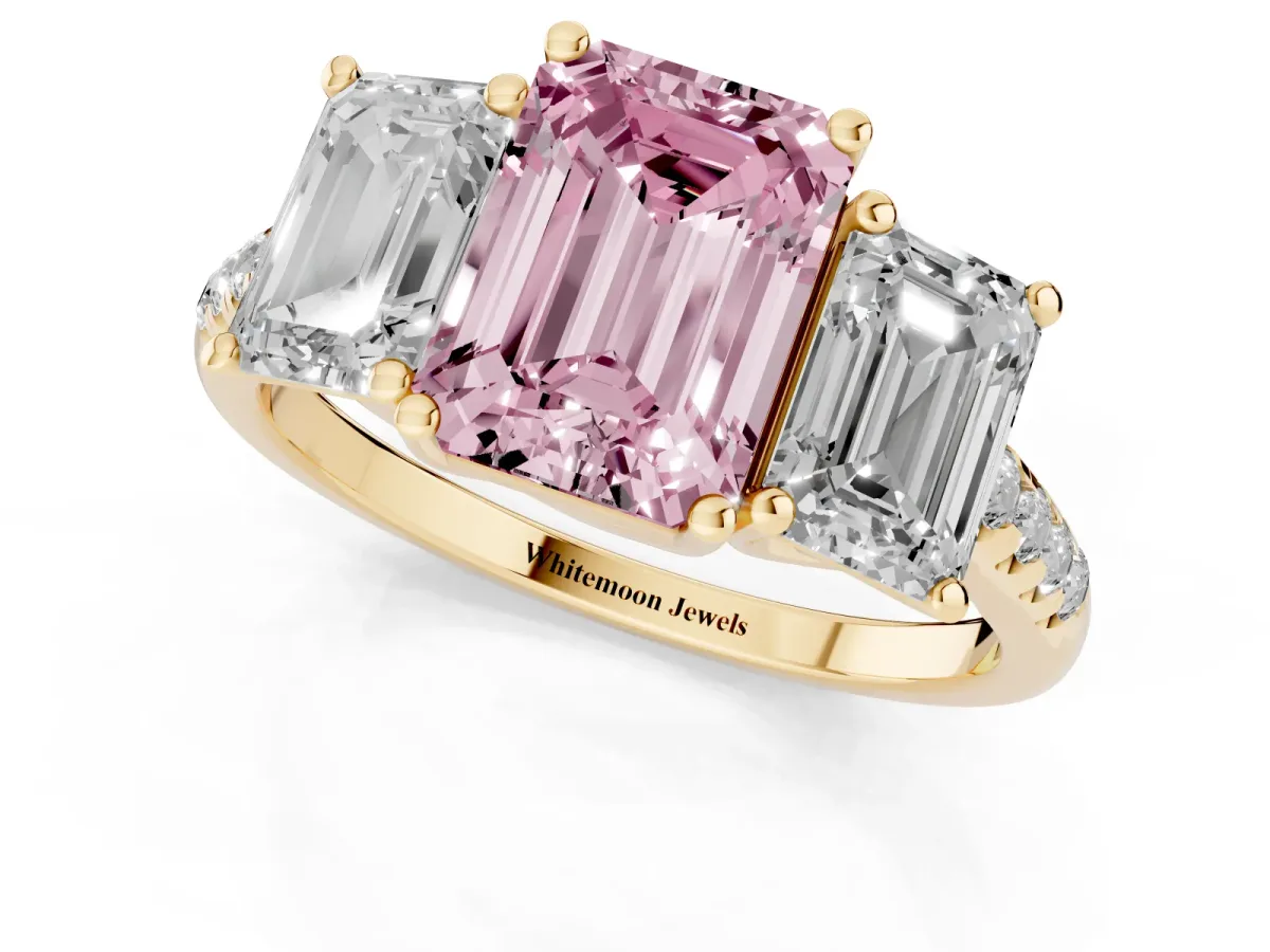Fancy Pink Three-Stone Emerald Cut Diamond Ring with Round Pavé Band and Prong Setting Yellow gold
