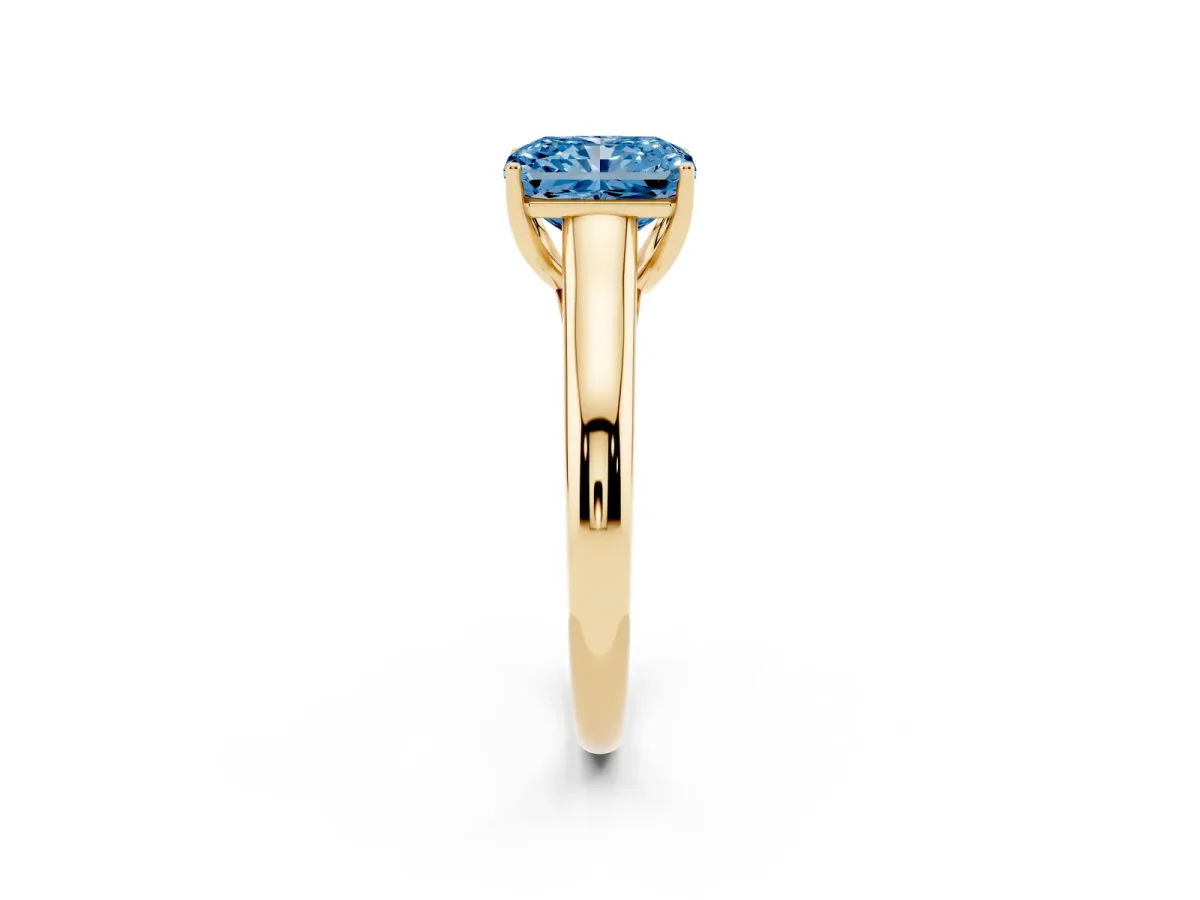 Fancy Blue Radiant Cut Solitaire Engagement Ring with Tapered Band and Four-Prong Setting Yellow gold