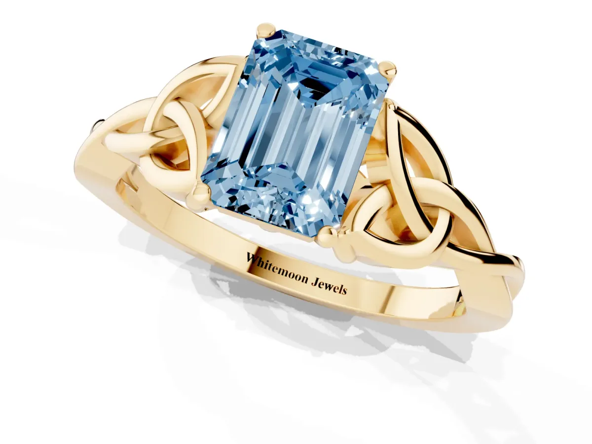 Fancy Blue Emerald Cut Diamond Solitaire Engagement Ring with Celtic Knot Band and Four-Prong Setting Yellow gold