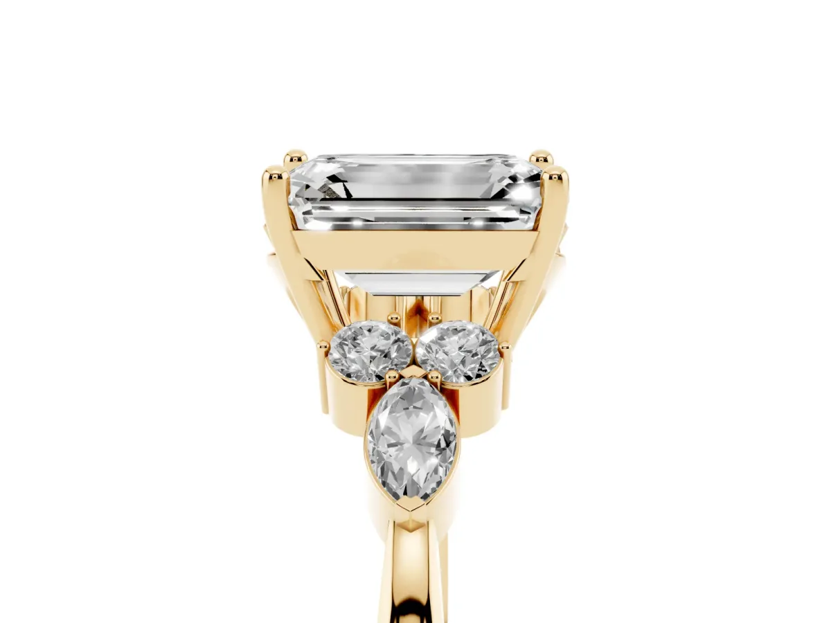 Emerald Cut Brilliant Diamond Solitaire Ring with Pear Side Stones and Four-Prong Setting Yellow gold