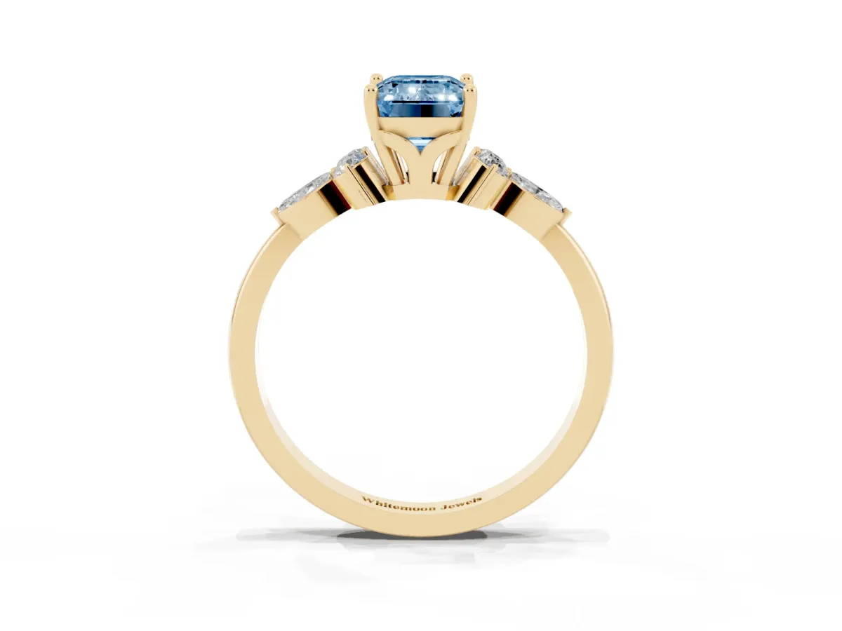 Fancy Blue Emerald Cut Brilliant Diamond Solitaire Ring with Pear Side Stones and Four-Prong Setting Yellow gold