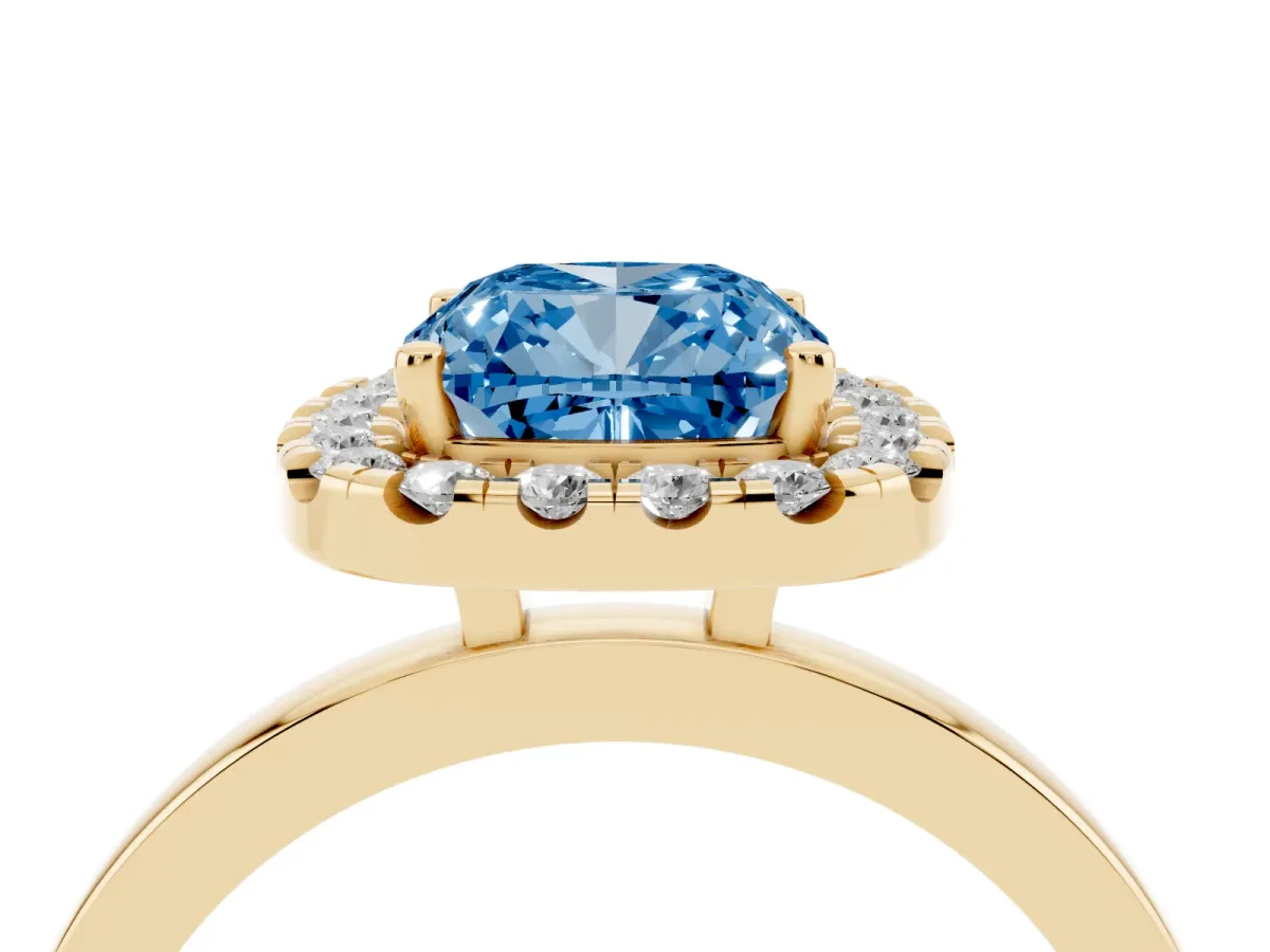 Fancy Blue Cushion Cut Halo Diamond Solitaire with Pavé Band and Four-Prong Setting Yellow gold
