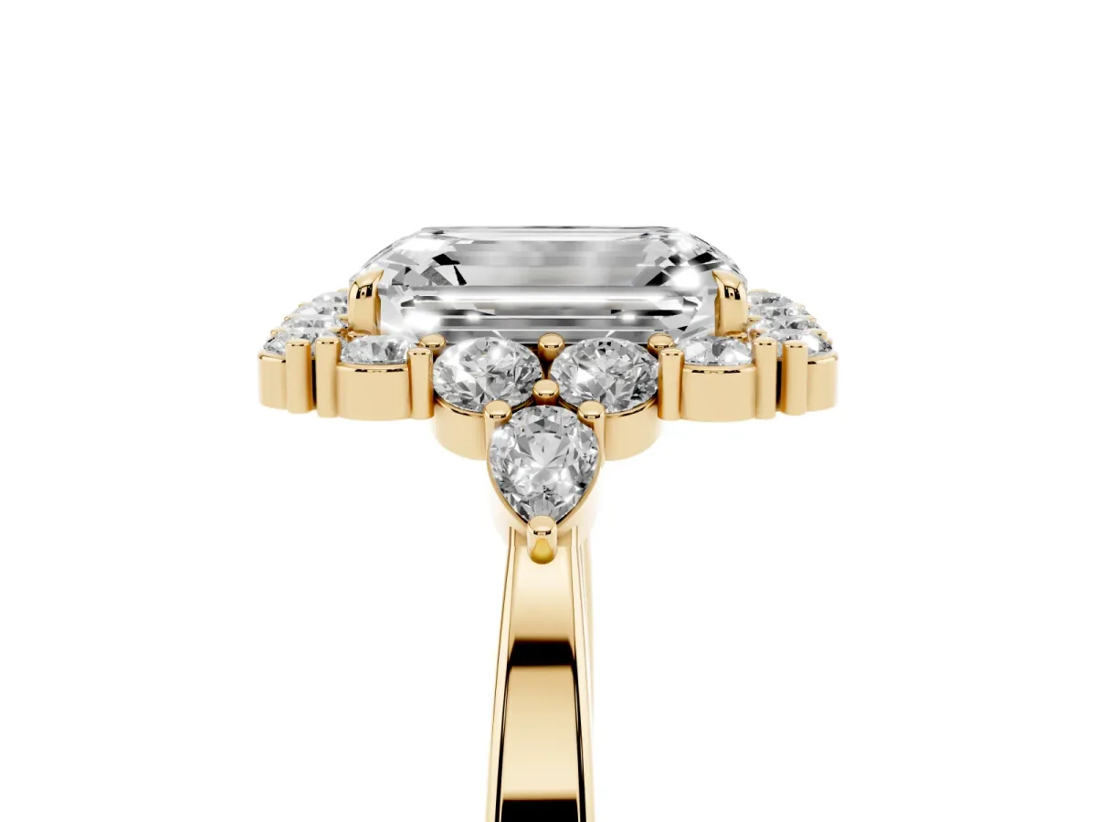 Emerald Cut Diamond Halo Ring with Pear Side Stones and Prong Setting Yellow gold