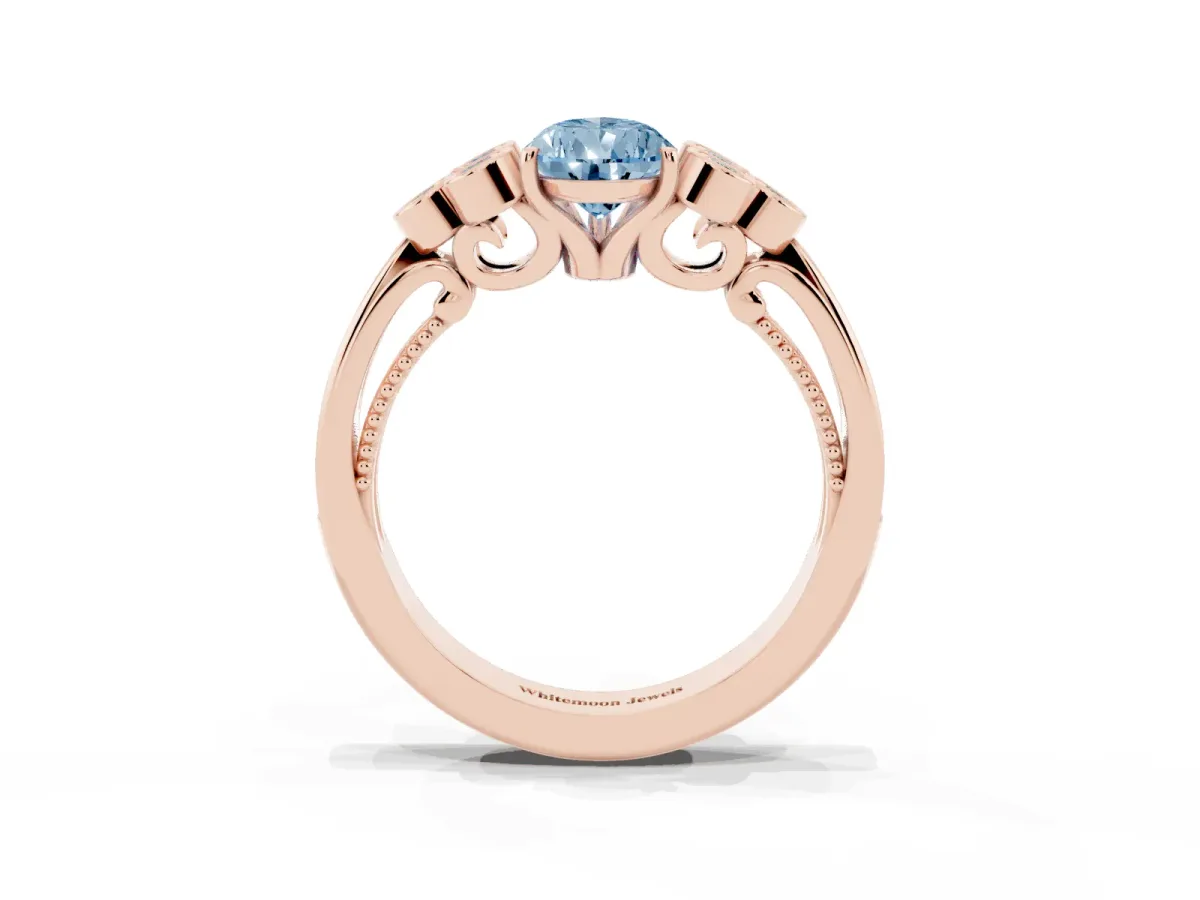 Fancy Blue Pear Cut Cut Diamond Engagement Ring with Bezel Set Round Side Stones and Prong Setting Rose gold
