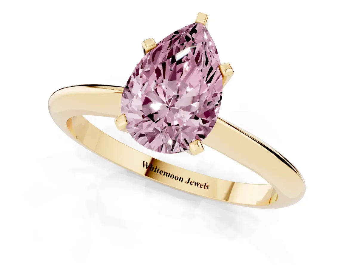 Fancy Pink Pear Cut Cut Solitaire Ring with Four-Prong Setting on a Classic Band Yellow gold