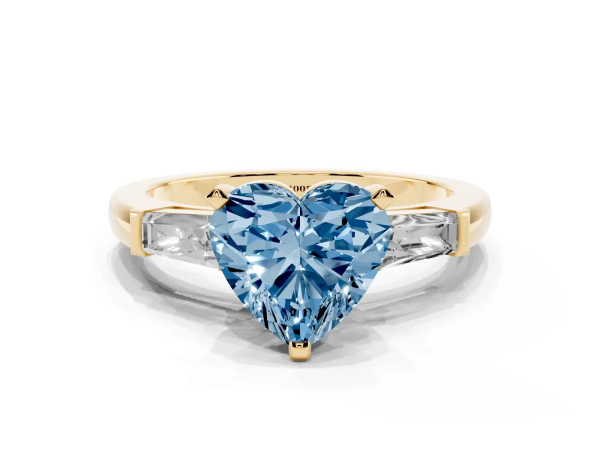 Fancy Blue Heart Cut Solitaire with Tapered Baguette Side Stones on a Classic Band with Four-Prong Setting Yellow gold