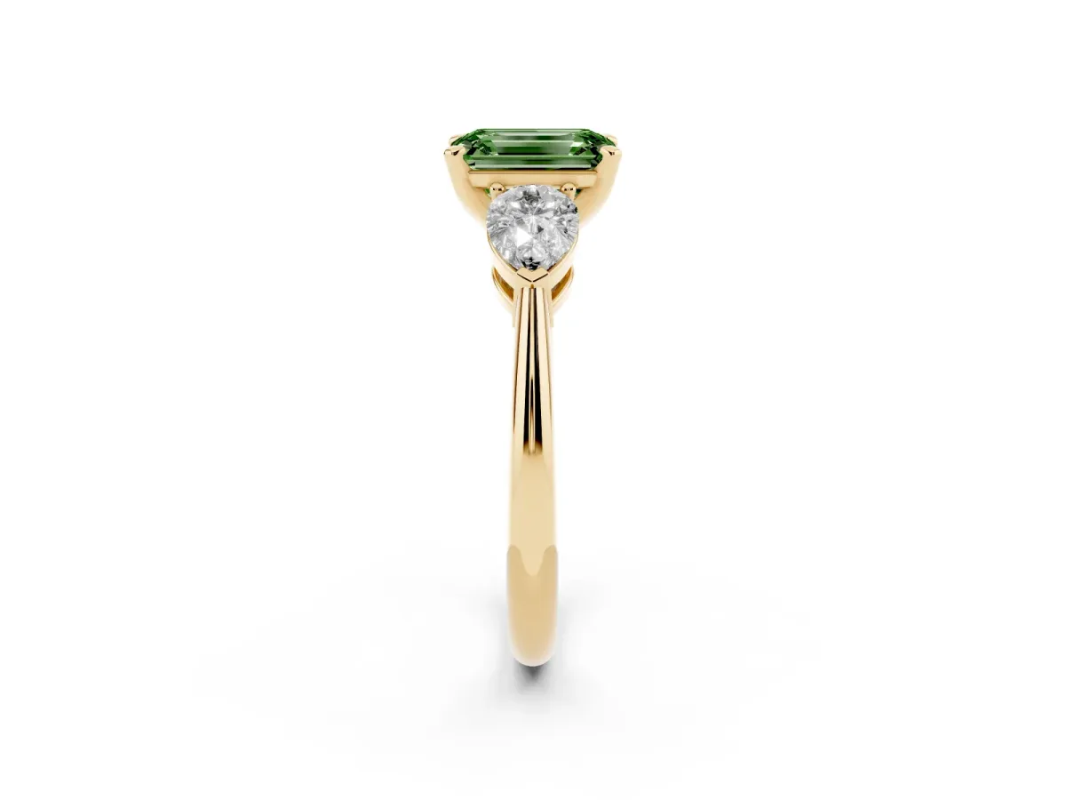 Fancy Green Three-Stone Emerald Cut Diamond Ring with Pear Side Stones and Four-Prong Setting Yellow gold