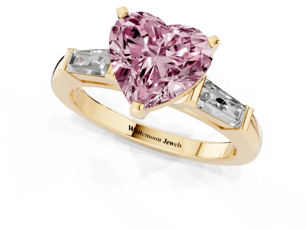 Fancy Pink Heart Cut Solitaire with Tapered Baguette Side Stones on a Classic Band with Four-Prong Setting Yellow gold