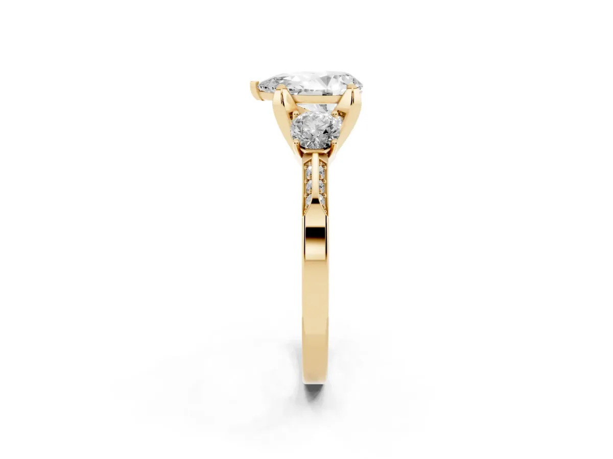 Pear Cut Brilliant Three-Stone Diamond Ring with Pavé Band and Four-Prong Setting Yellow gold