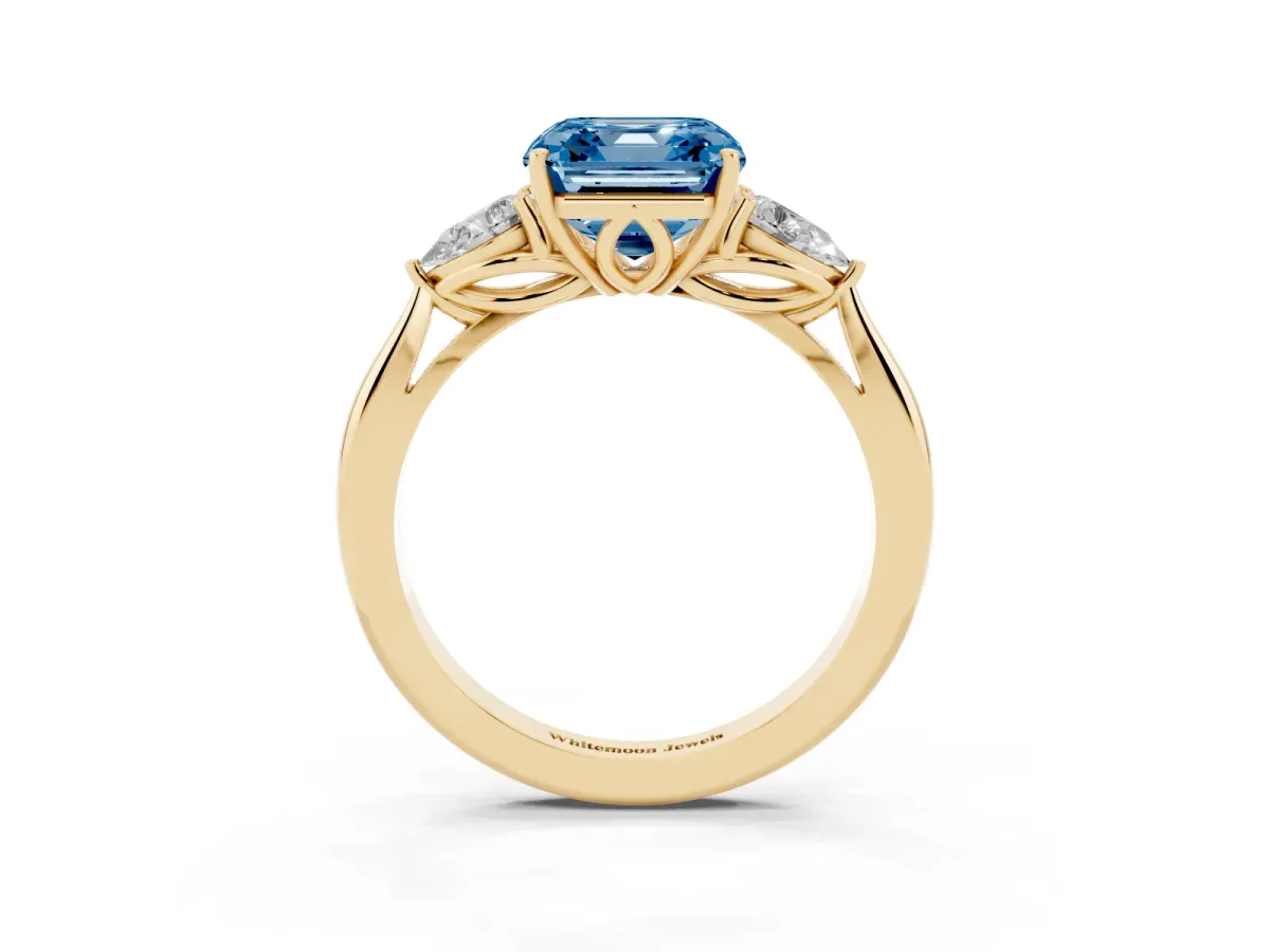 Fancy Blue Three-Stone Asscher Cut Diamond Ring with Pear Side Stones in Four-Prong Setting Yellow gold