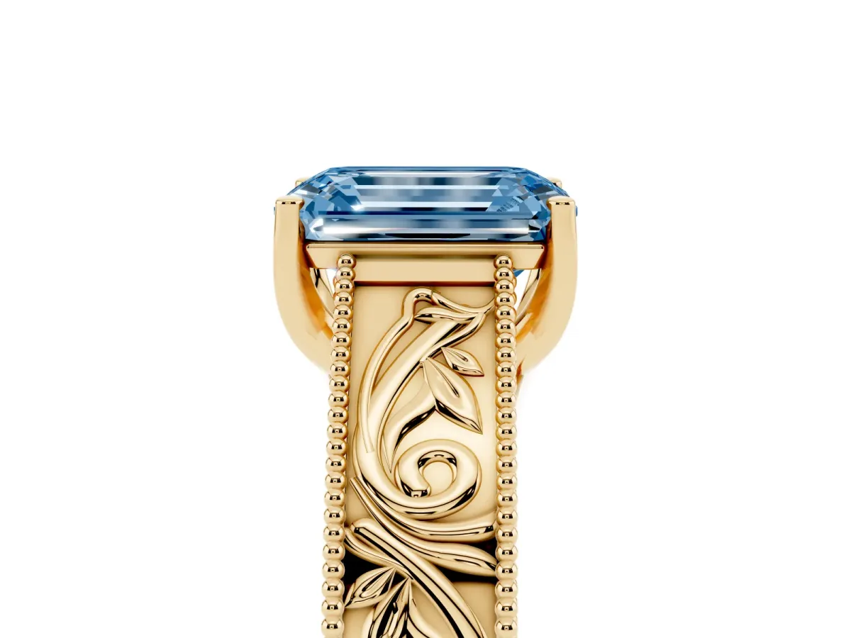 Fancy Blue Emerald Cut Diamond Solitaire Ring with Engraved Band and Four-Prong Setting Yellow gold