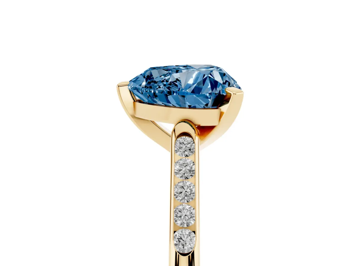 Fancy Blue Heart Cut Diamond Solitaire Ring with Channel Set Round Band and Prong Setting Yellow gold