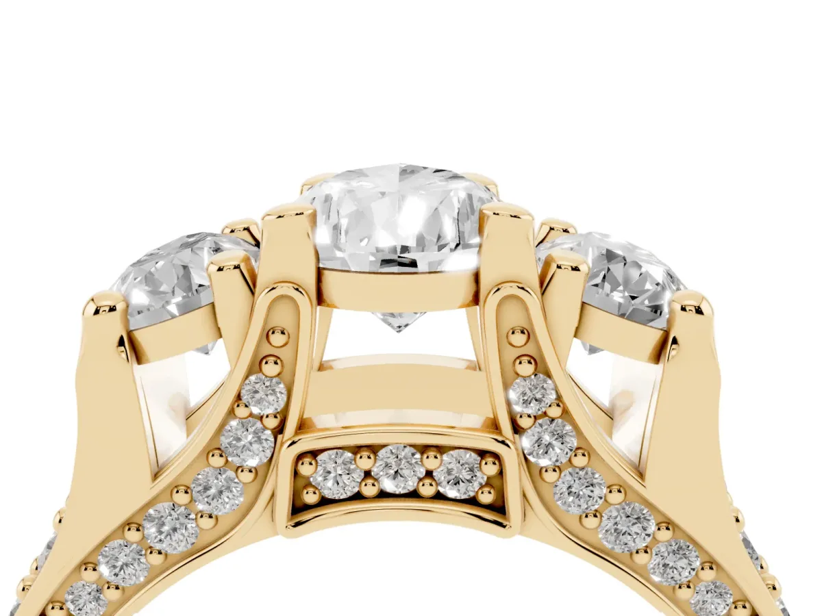Pear Cut Diamond Three-Stone Ring with Channel Set Band and Four-Prong Setting Yellow gold