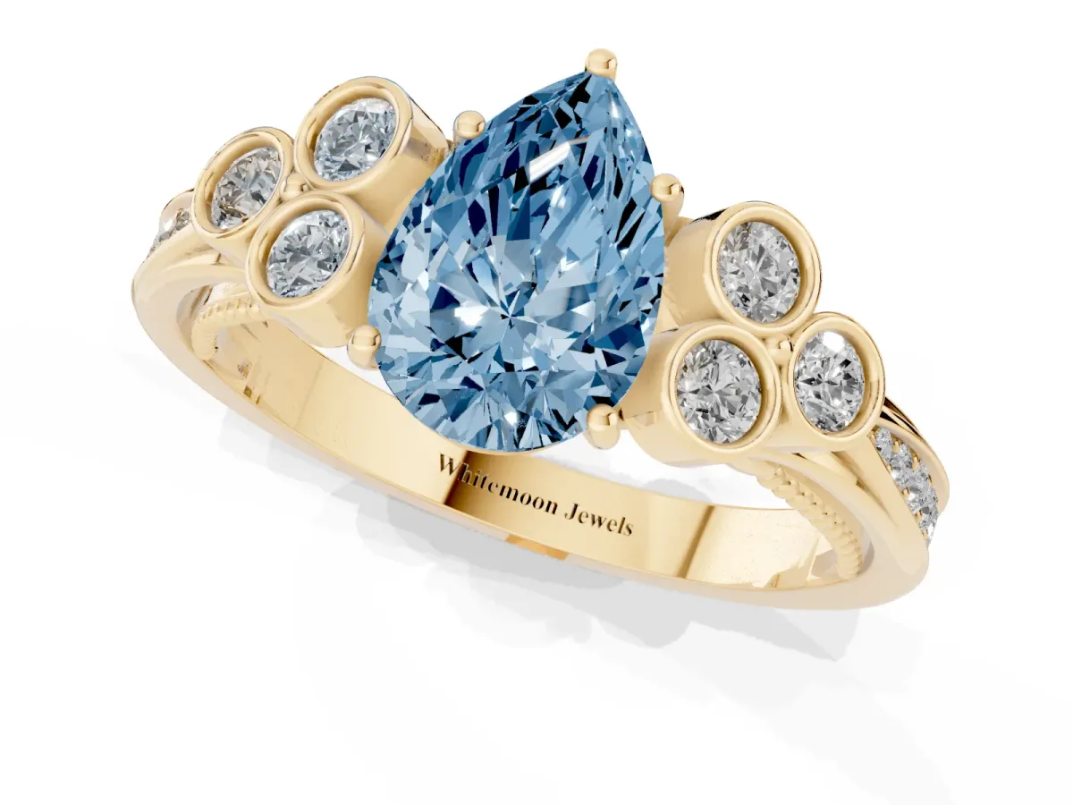 Fancy Blue Pear Cut Cut Diamond Engagement Ring with Bezel Set Round Side Stones and Prong Setting Yellow gold