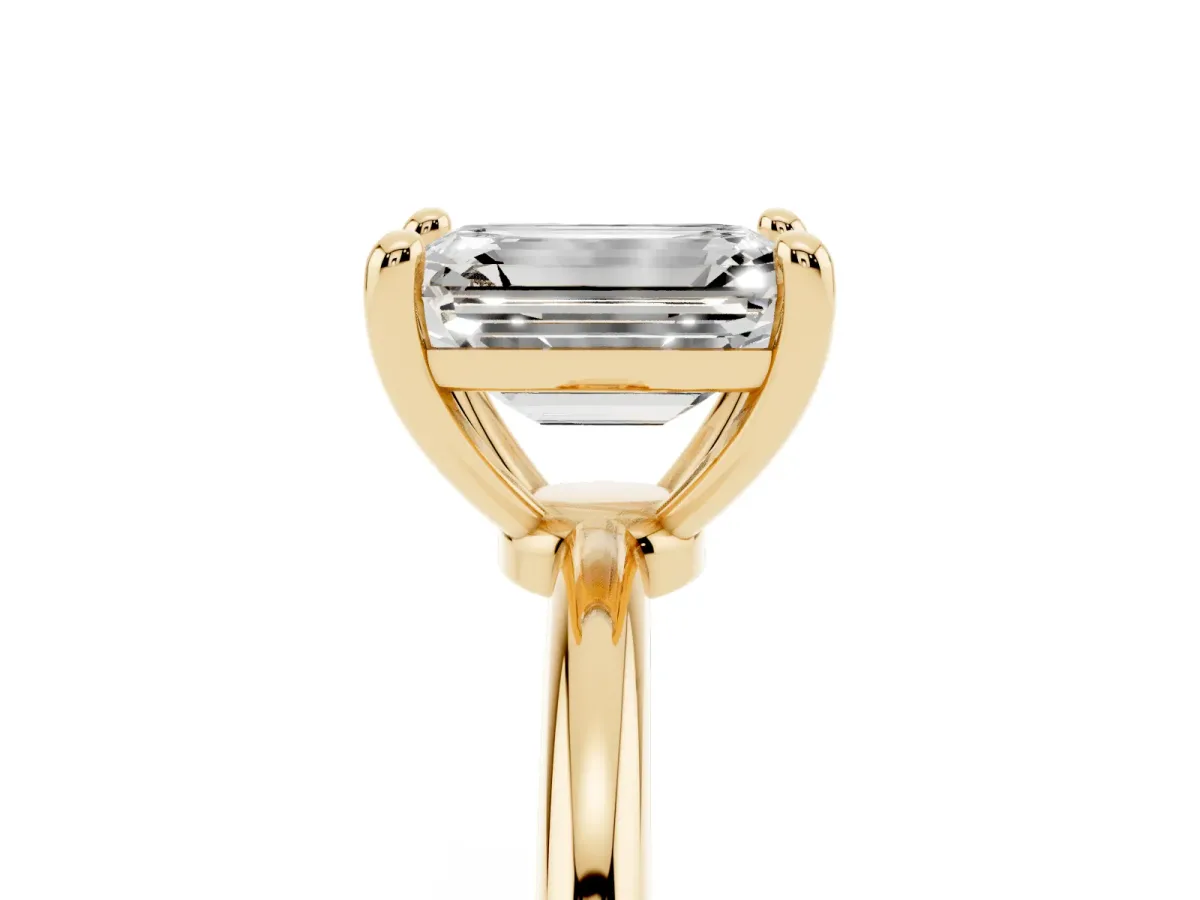 Emerald Cut Solitaire Diamond Ring with 4-Prong Setting on a Classic Band Yellow gold