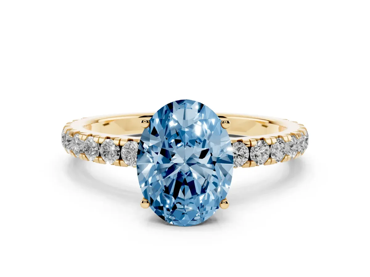 Fancy Blue Oval Cut Diamond Pavé Solitaire Engagement Ring with Four-Prong Setting Yellow gold