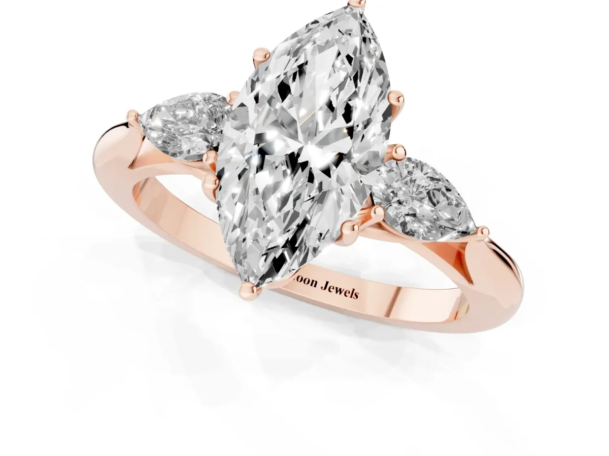 Three-Stone Marquise Cut Diamond Ring with Pear Side Stones in Four-Prong Setting Rose gold