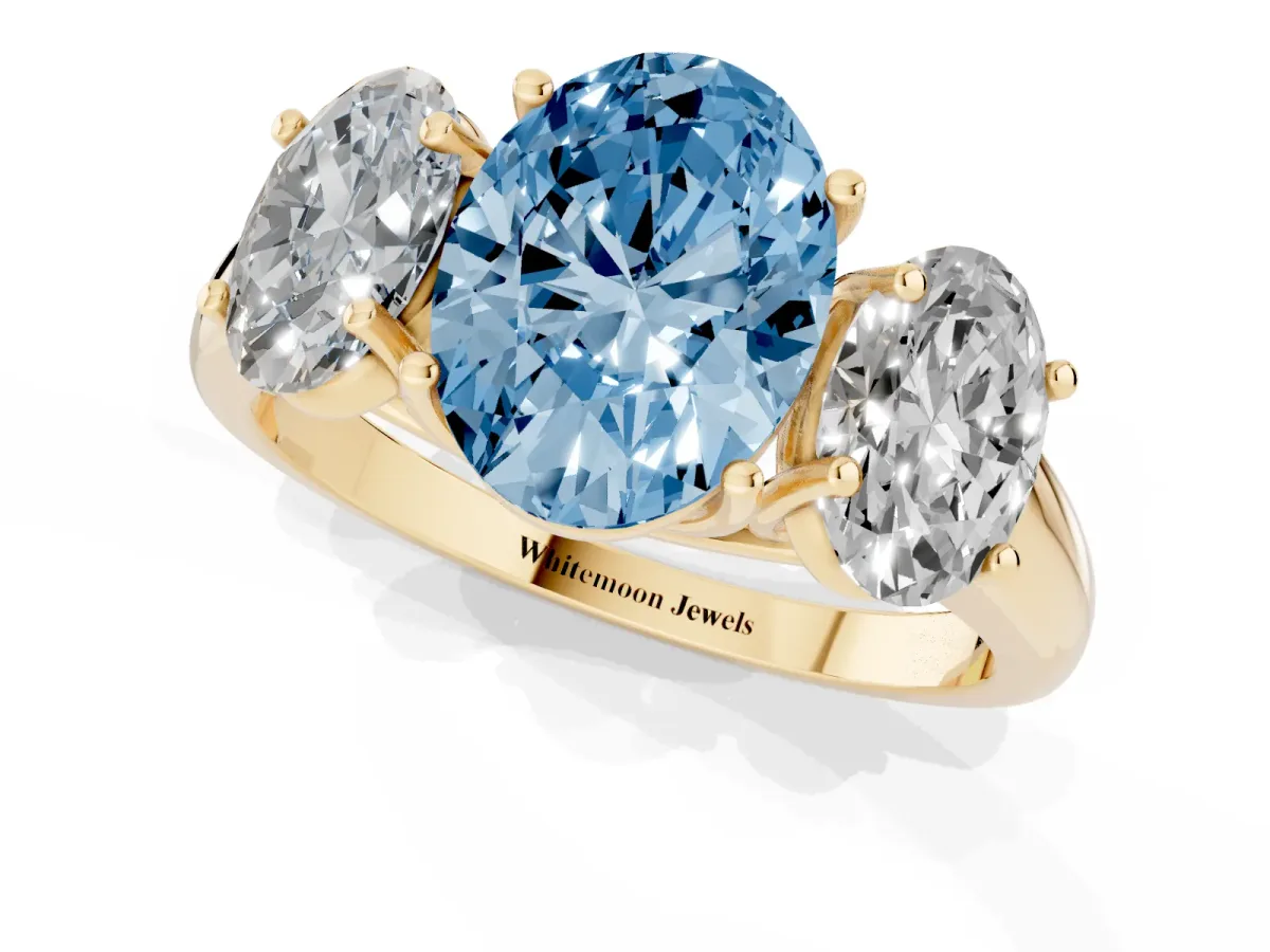 Fancy Blue Three-Stone Oval Cut Diamond Engagement Ring with Prong Setting Yellow gold