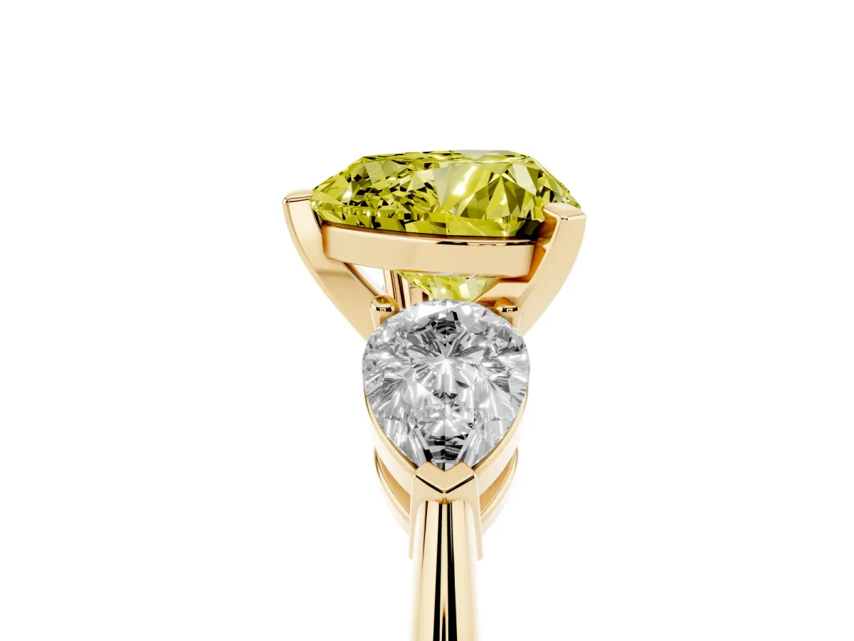 Fancy Yellow Three-Stone Heart Cut Diamond Ring with Pear Side Stones and Four-Prong Setting Yellow gold